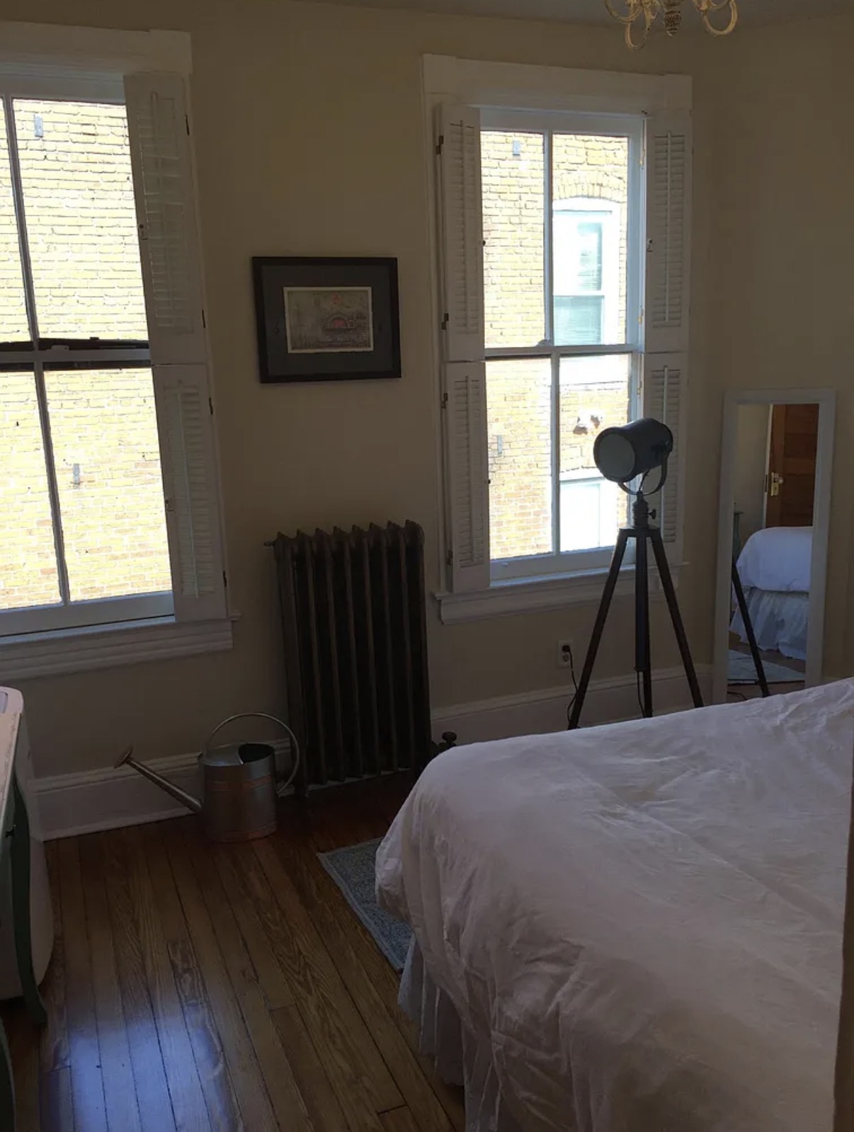 Bedroom with tall shuttered windows